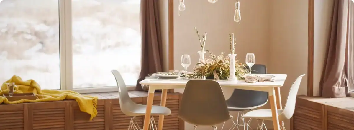 Modern dining room with elegant table setting, floral centerpiece, and large windows offering natural light - ideal for property investors in Tanzania.