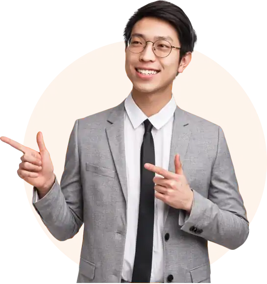 Stylish young man in a grey suit smiling and pointing, over an orange circle background, representing property investment opportunities in Tanzania.