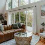 Cozy living room with large windows showcasing scenic views, modern furniture, and natural light, in a Tanzanian property highlighting luxury home features in Tanzania.